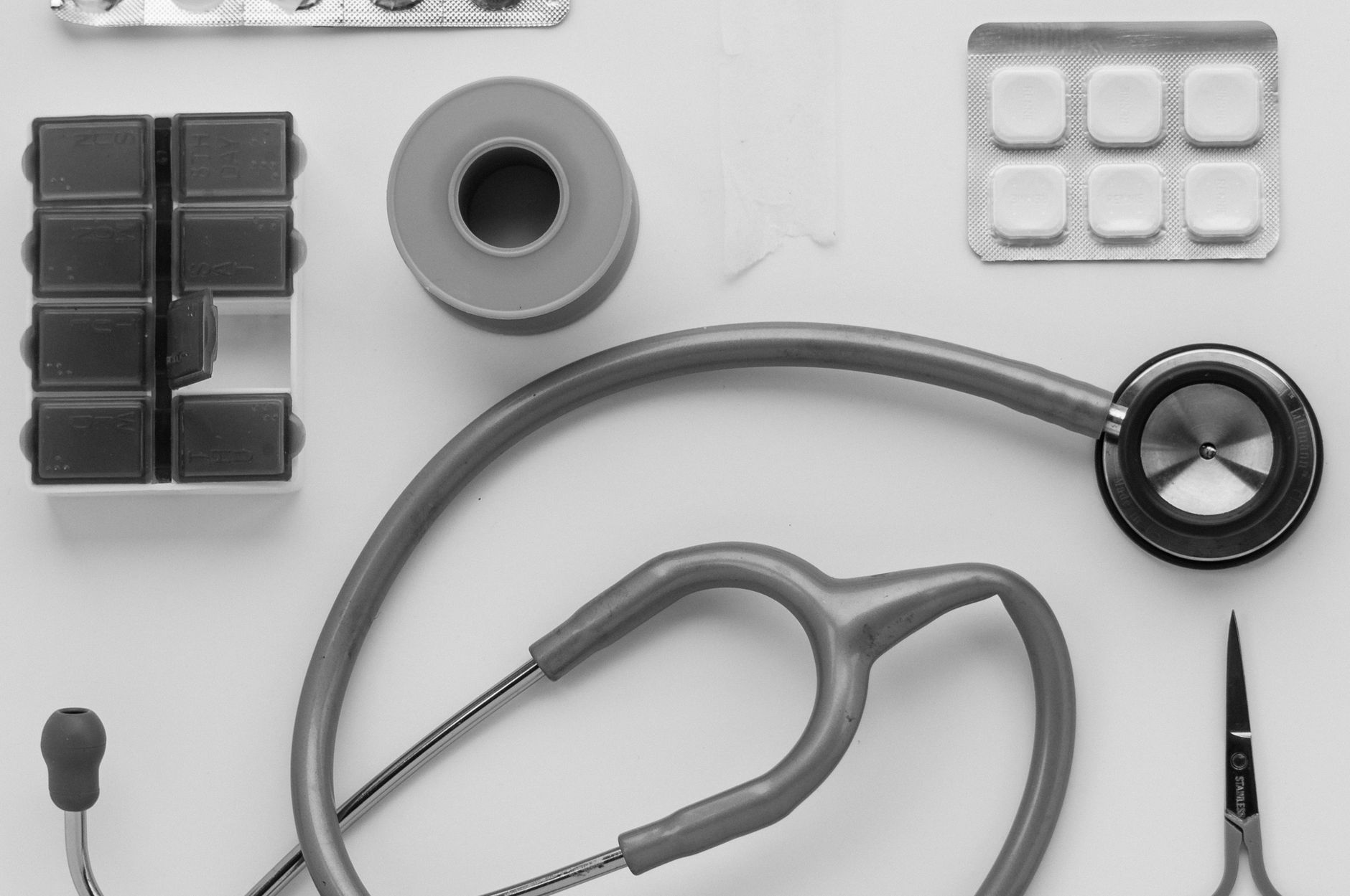Top view of medical instruments and pills arranged on a white background. — Baby products- A medium that can lead to the heal