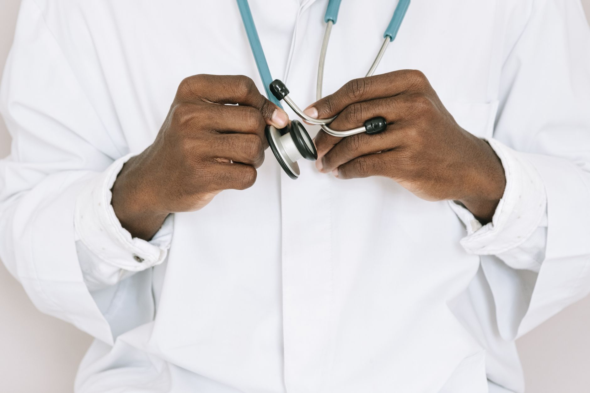 A professional doctor holding a stethoscope, focusing on hands and medical tools. — Benefits of CBD products on humans