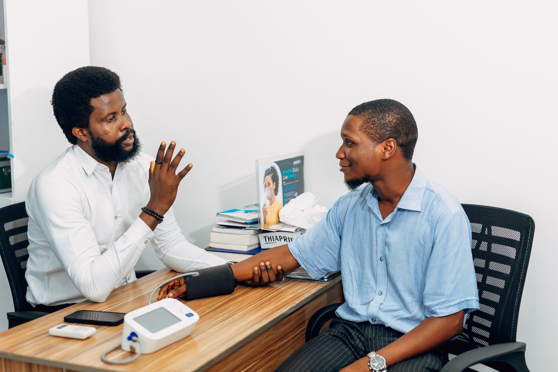 A medical professional consults with a patient during a blood pressure checkup in Lagos, Nigeria. — CBD Vape Pens Popularity