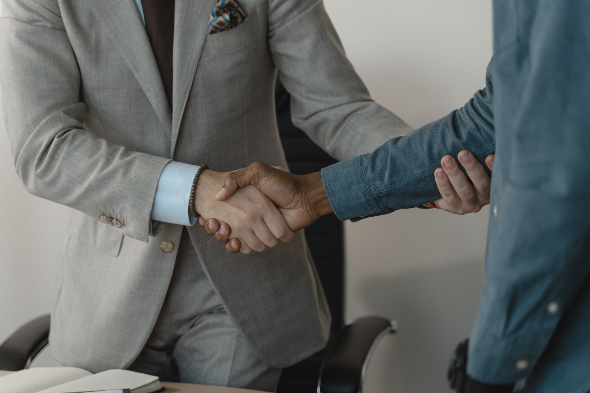 Image of a professional handshake between two businessmen in an office setting. — Exploring the Different Types of Vape Mods