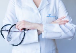 A close-up image of a doctor in a white coat with a stethoscope and arms crossed. — Health For that Soul and Spirit