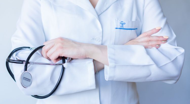 A close-up image of a doctor in a white coat with a stethoscope and arms crossed. — Health For that Soul and Spirit