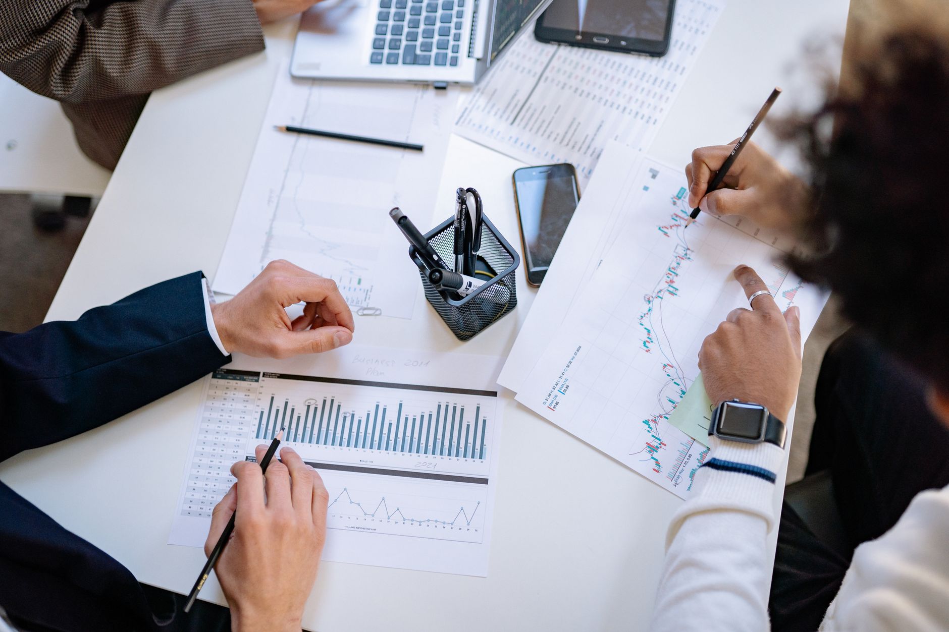 Business team analyzing financial charts and graphs during a collaborative meeting. — High Voltage Vapes: Premium E-Liquids a