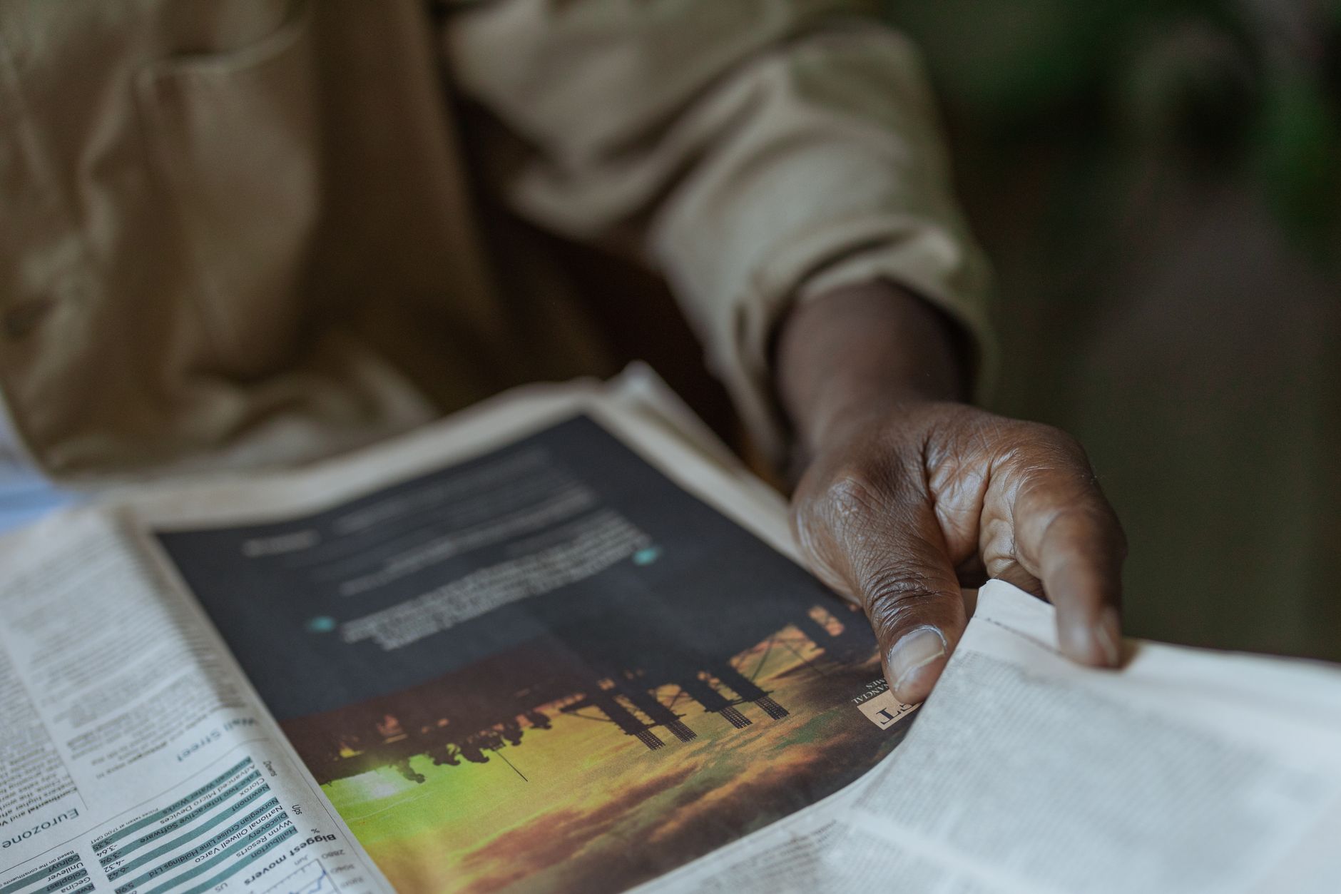 Detailed close-up of a person holding and reading a newspaper indoors. — How to Bypass Your Water Softener: A Step-by-Step Gu