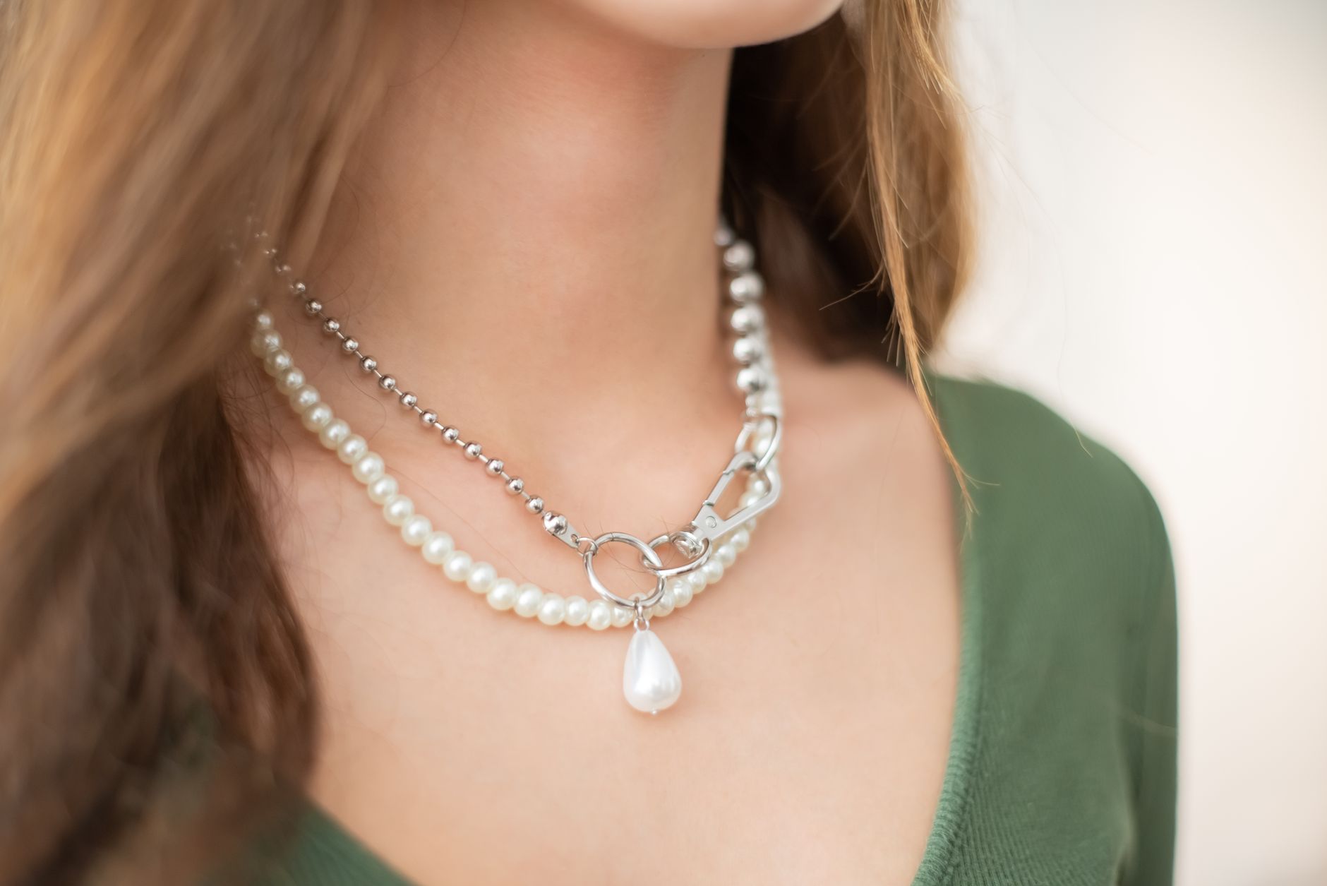 Close-up of a woman's neck adorned with elegant layered pearl necklaces. — Salon Equipment