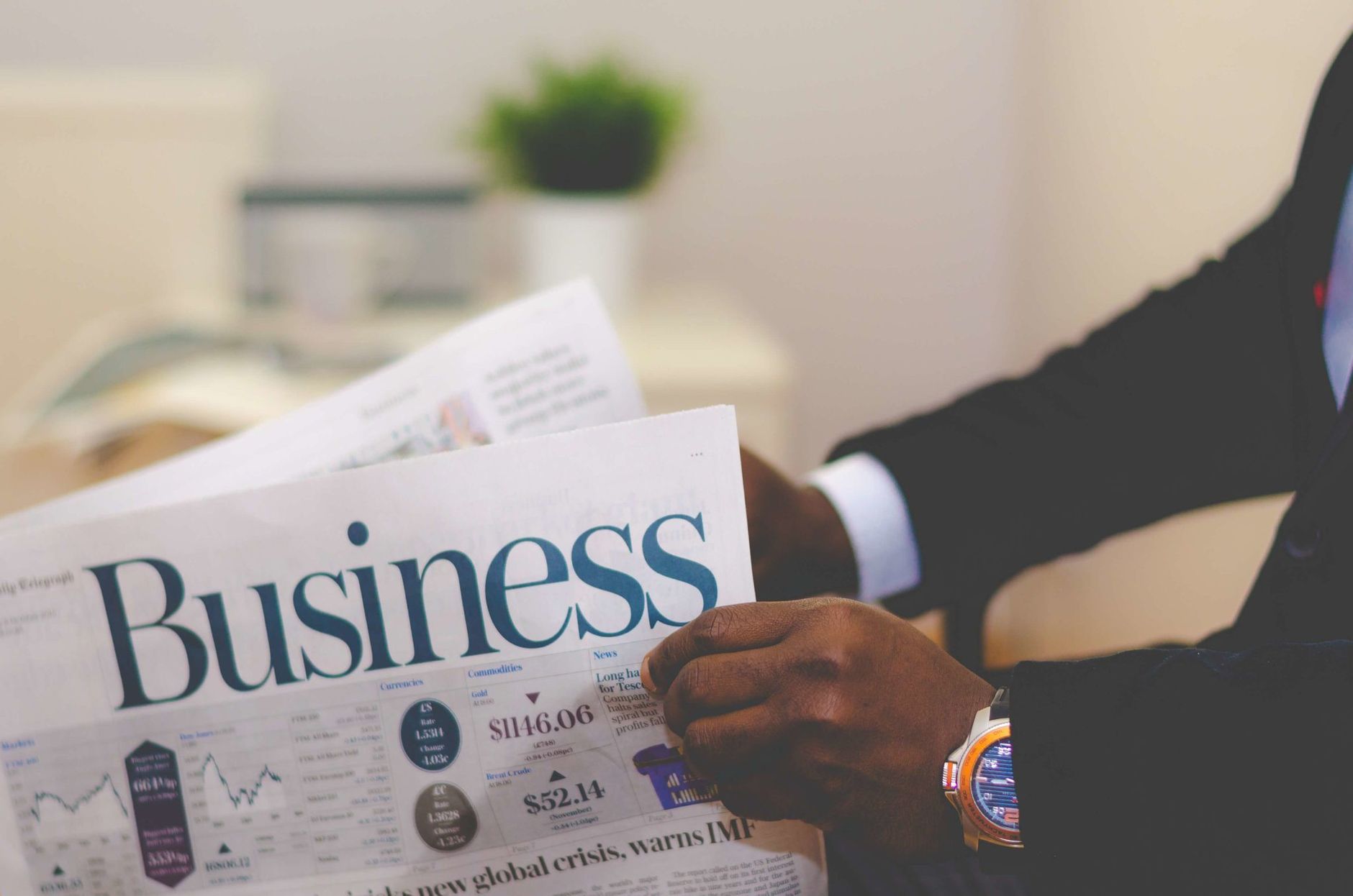 Close-up of a businessman reading a newspaper indoors, focusing on business headlines. — The Advantages of a Waterproof Halo