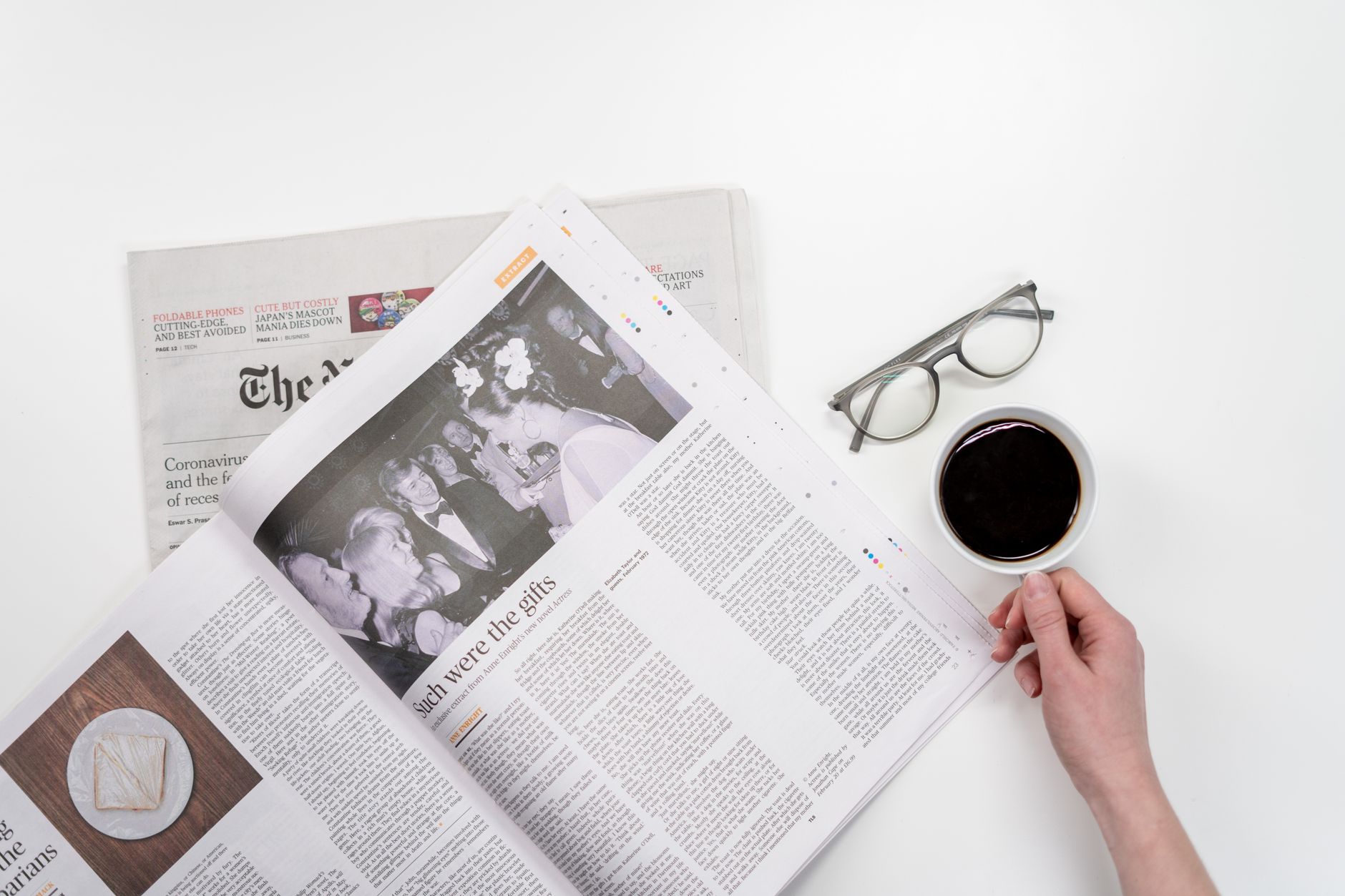 Overhead view of newspaper reading with coffee and glasses on a white table. — The Benefits of Going to Drug Rehab