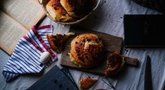 Artistic flat lay of freshly baked rustic bread with ingredients on a wooden board. — The Best Way To Store Emergency Food