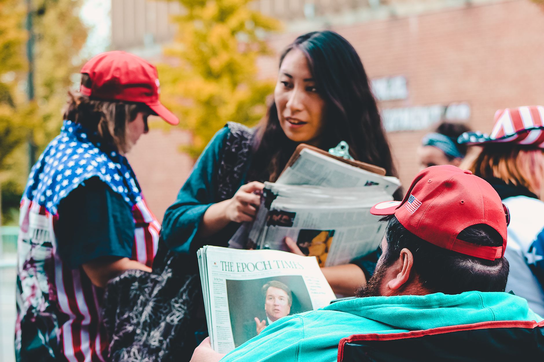A group of adults reading newspapers outdoors, immersed in political discussions on a vibrant day. — The New Plastic Surgery