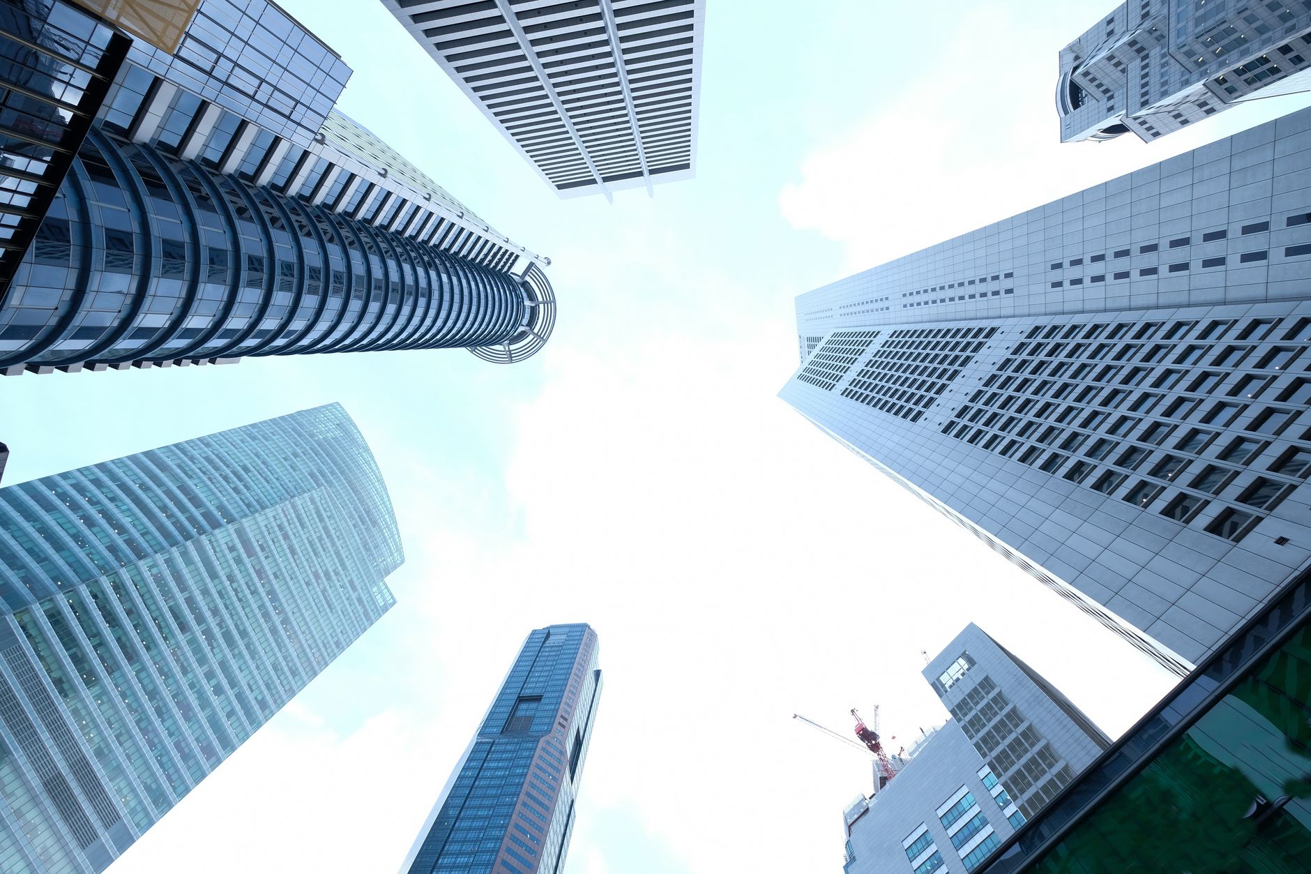 A striking upward view of various skyscrapers in an urban setting against a clear sky. — The Role of Revive Collagen in Anti-