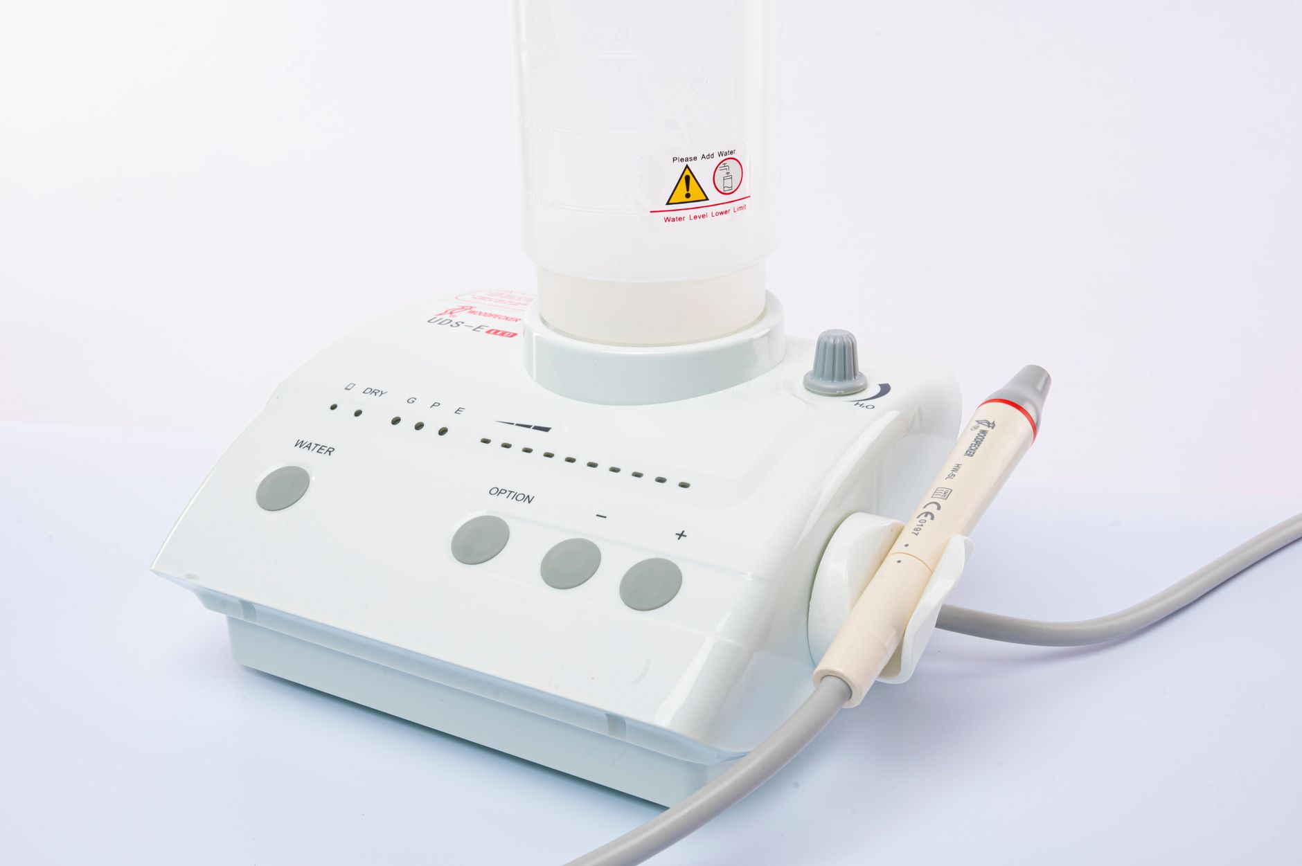 Close-up of a dental ultrasonic scaler with water supply on a white background. — Top Dental and Vision Insurance Bundles for