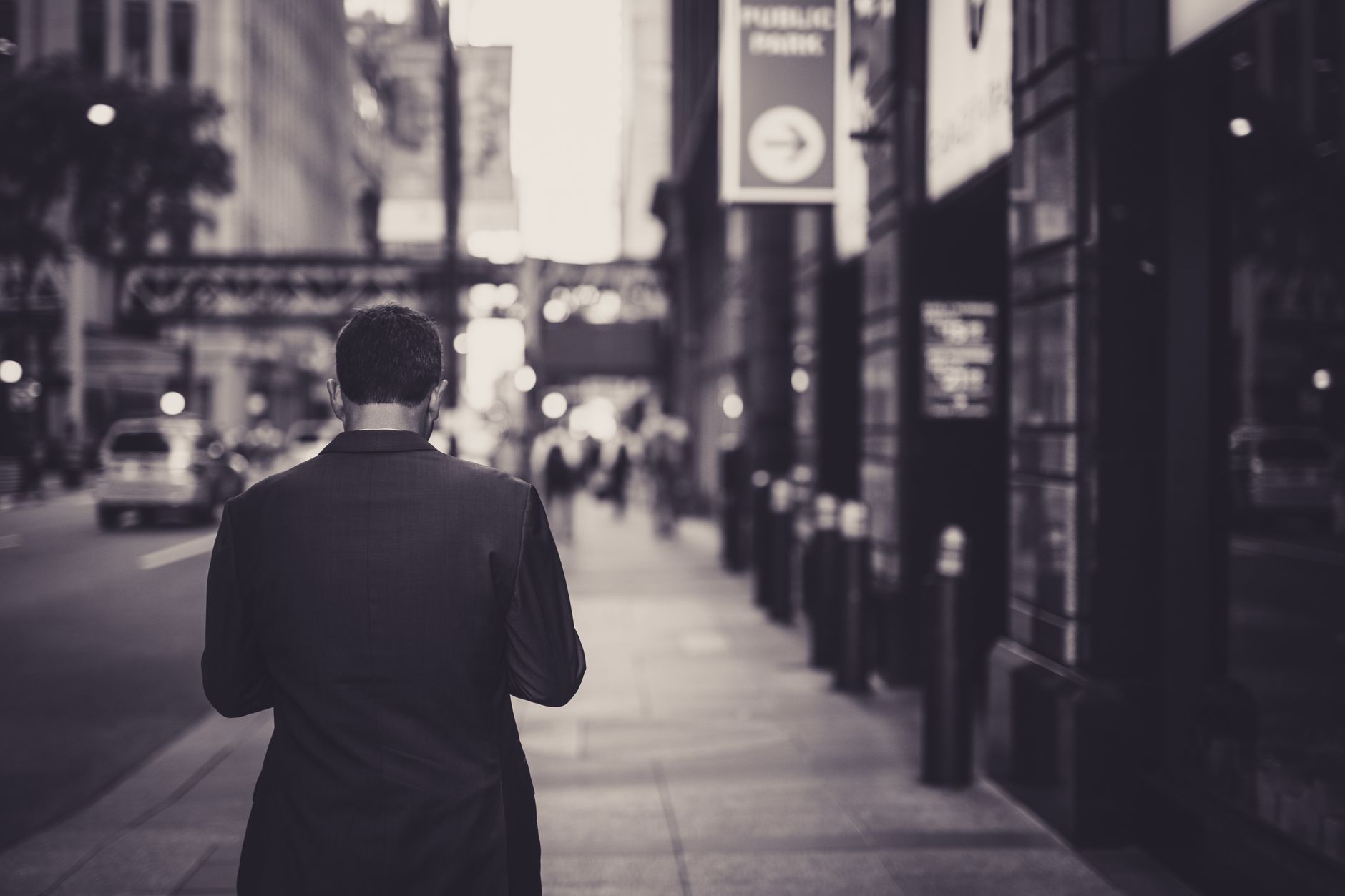 Man in a suit walking down a city street in a lonely, urban setting. — Understanding the Dosage and Side Effects of TX250 Tes