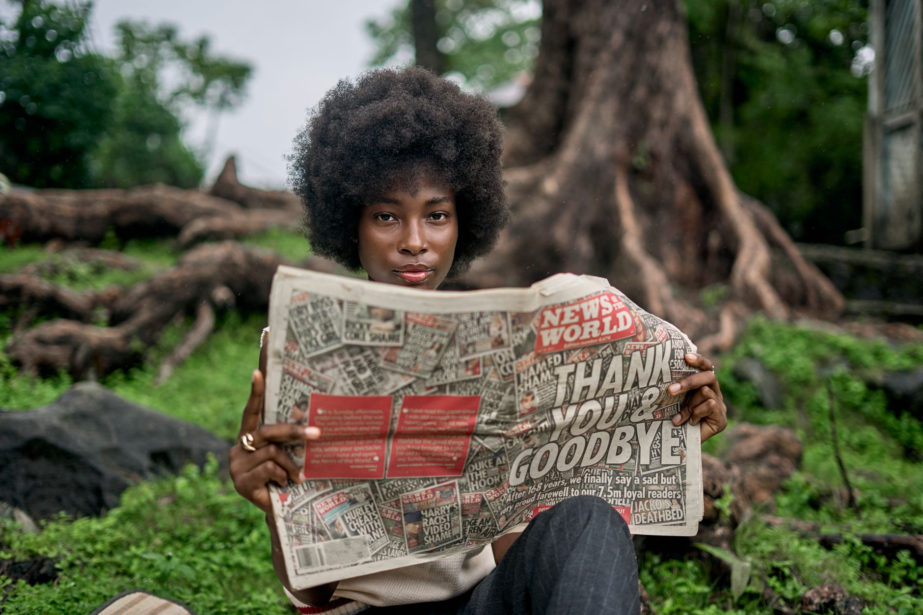 A woman enjoys reading a newspaper in a natural outdoor setting, showcasing leisure and nature. — What Are The Things That A