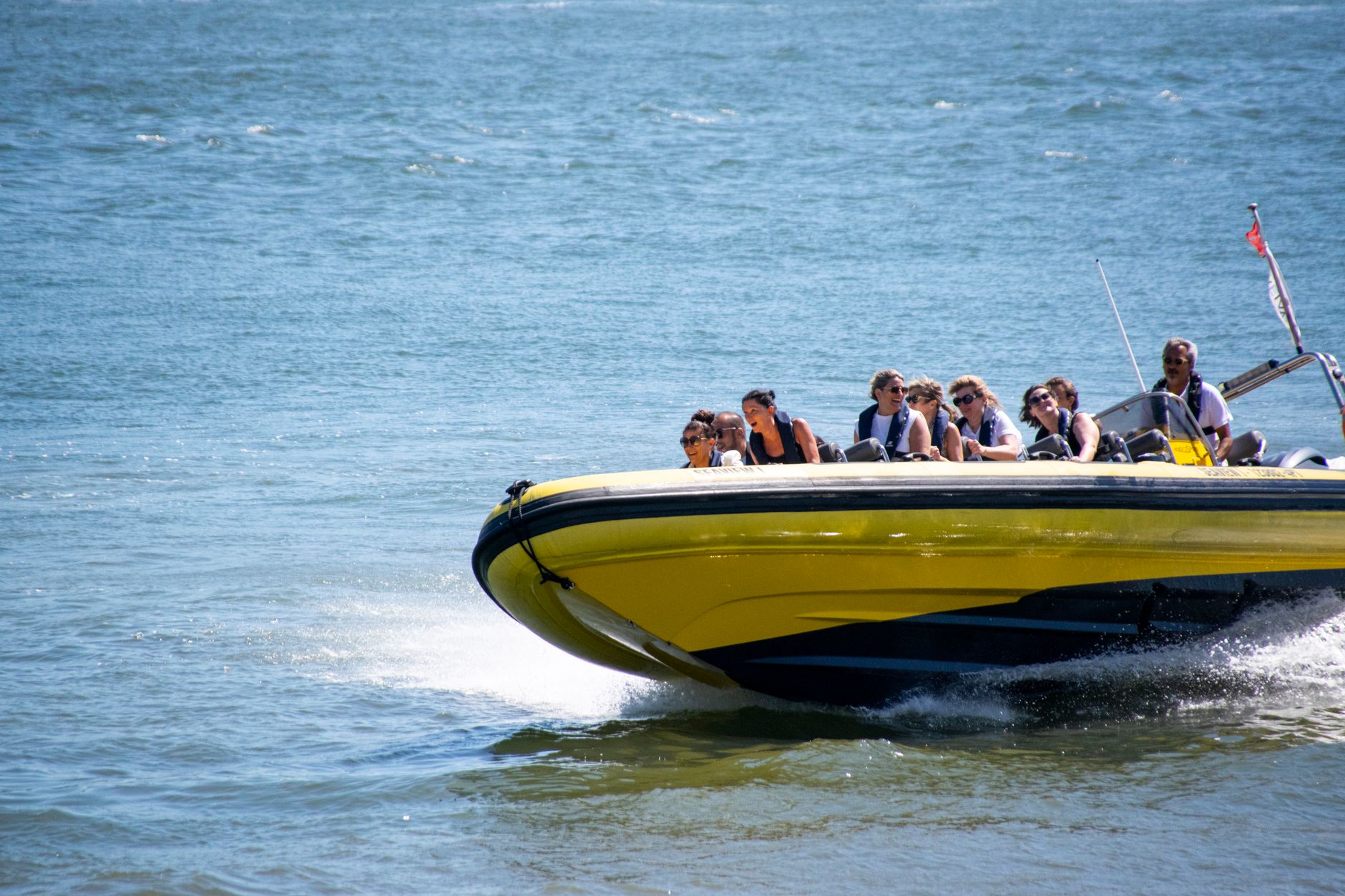 Thrilling speedboat ride with passengers exploring the Tejo River in Lisbon, Portugal. — Why You Should Visit a Pain Clinic f