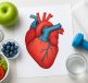 Illustration of a human heart surrounded by healthy foods and fitness items, emphasizing heart health.